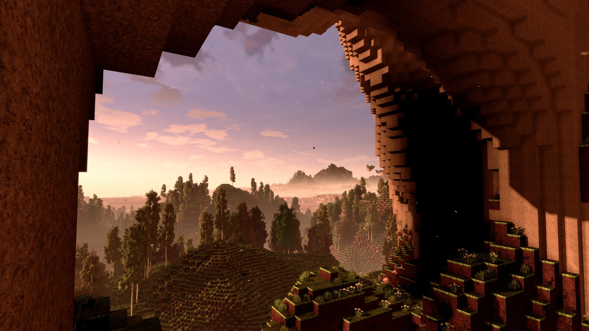 View from inside a cyubeVR cave mouth out to a pink-and-gold sunrise over forested voxel hills